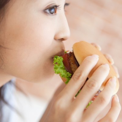 Young woman eating a hamburger
