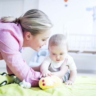 Teenage girl playing with baby boy