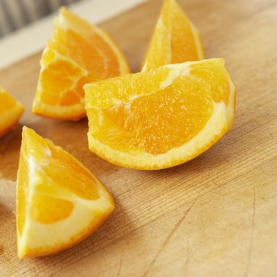 Sliced oranges on cutting board, close up