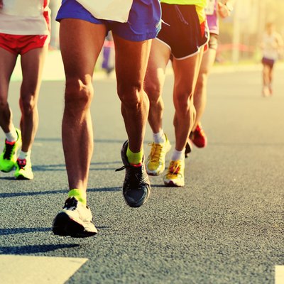 Marathon running race, people feet on city road