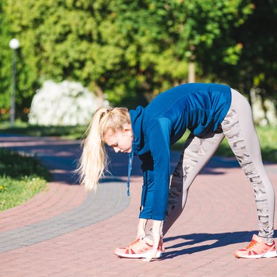 Fitness woman doing exercises during outdoor cross training workout in
