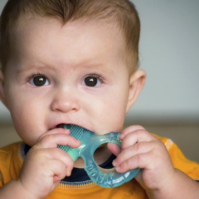 Baby chewing on teething ring