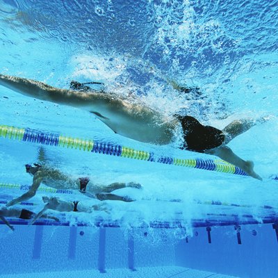 Male swimmers racing in pool, underwater view