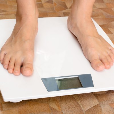 pair of female feet standing on the scale