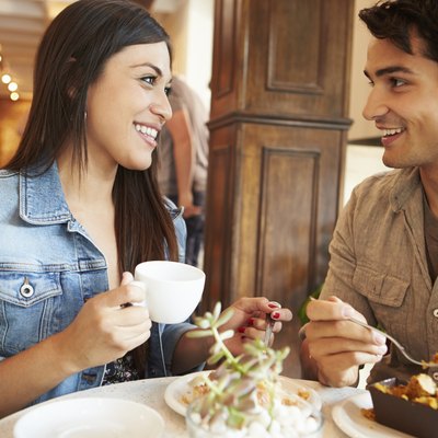Couple Meeting In Busy Café Restaurant
