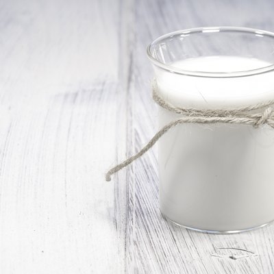 glass of milk on white wooden table