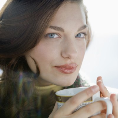 Portrait of young woman drinking coffee