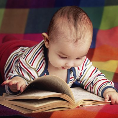 cute little baby reading book