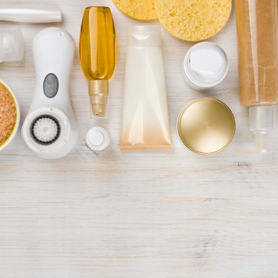 Beauty treatment products on wooden background with copyspace at bottom