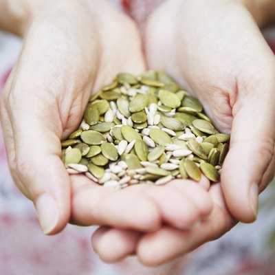 Woman Holding A Handful Of Healthy Seeds