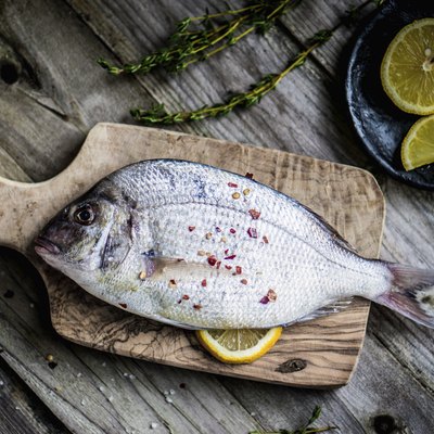 Fresh sea bream on wooden board