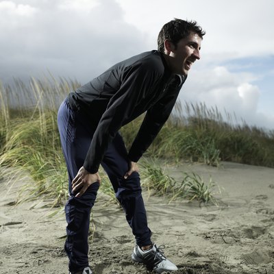 Man bending over on beach