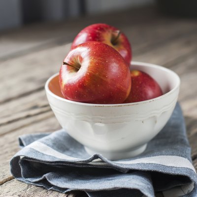 Composition with Red Apples on the wooden table, square image