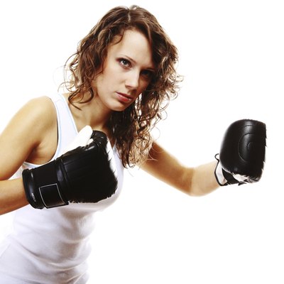 Fit woman boxing - isolated over white