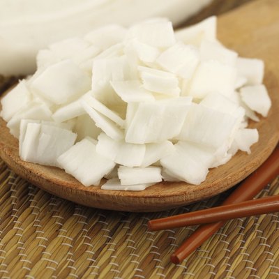 Sliced coconut with chopstick