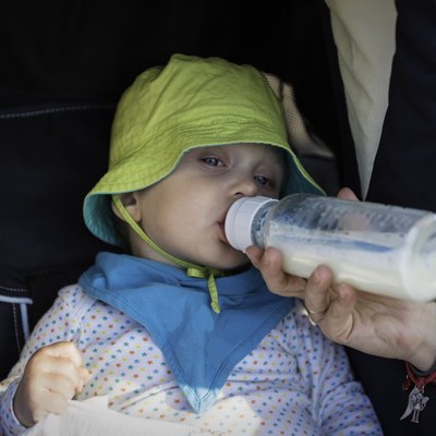 Baby drinks milk from a bottle
