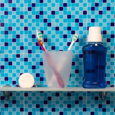 Toothbrushes on bathroom shelf