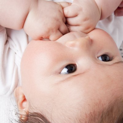 Asian baby girl in parent's care