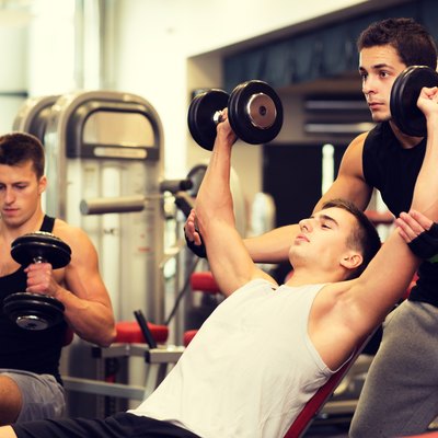 group of men with dumbbells in gym