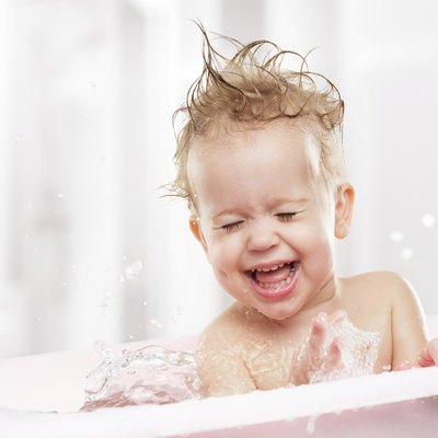 happy funny baby laughing and bathed in bath
