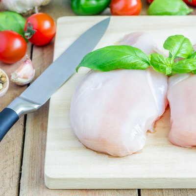 Raw chicken fillet with herbs and vegetables