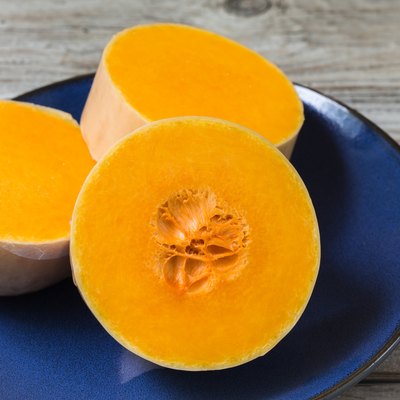 three thick slices of butternut squash in blue plate.