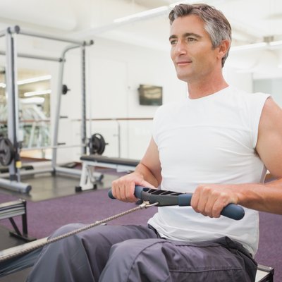 Fit man working out on rowing machine