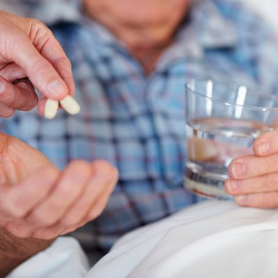 Closeup of a senior man being given a life saving pill