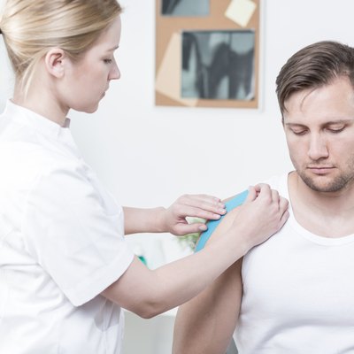 Physiotherapist applying kinesiology tape