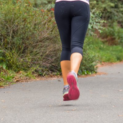 Young woman running on trail