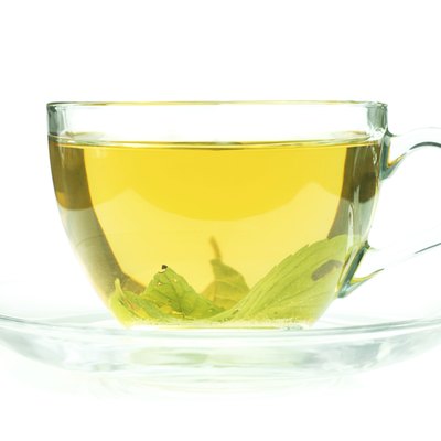Cup of fresh green tea isollated on white