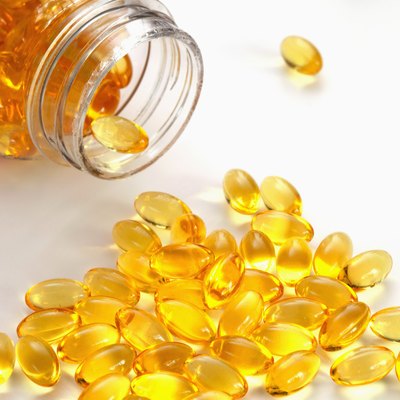 Cod liver oil capsules spilling from container