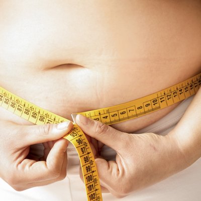 checking fats on her body with a meter