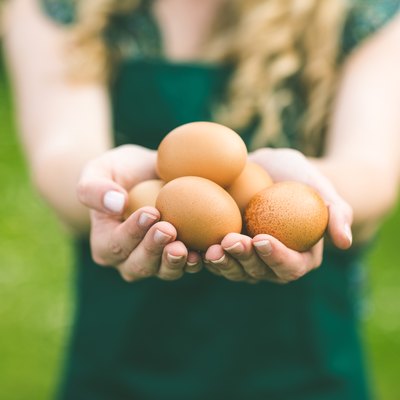 Young woman showing eggs