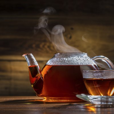 glass teapot and mug on the wooden background