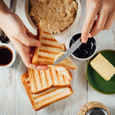 Man hands eating toast for breakfast