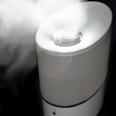 Humidifier spreading steam in darkness