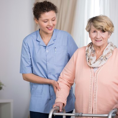 Senior woman and supporting nurse