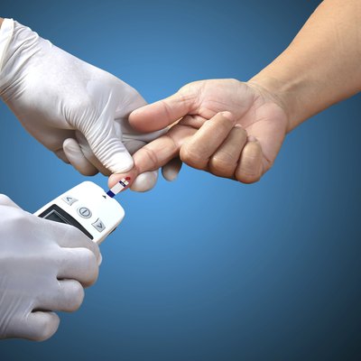 Doctor testing blood sugar value is measured on a finger
