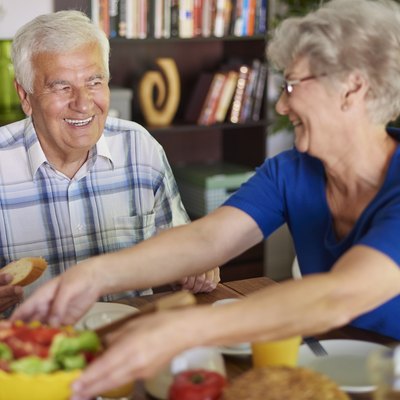 Senior couple eating delicious breakfast
