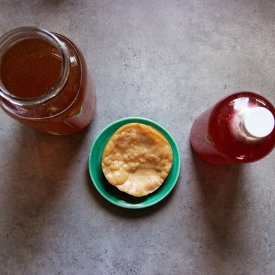 Homemade kombucha: fermented tea brewing, mother, bottled with raspberry