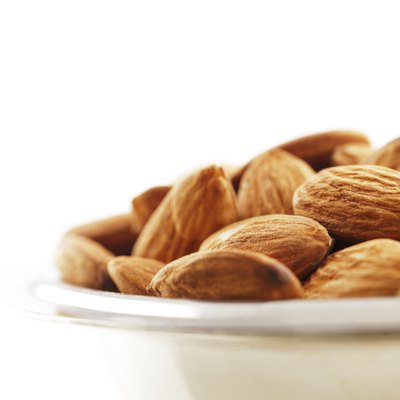Bowl of almonds on a white background