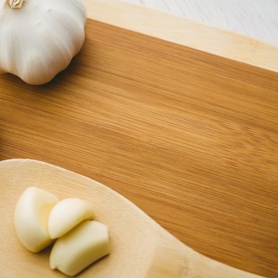 Garlic cloves and bulb on chopping board
