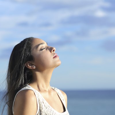 Beautiful arab woman breathing fresh air in the beach