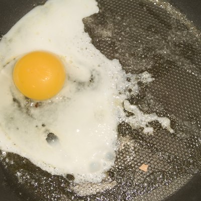 Close-up of a fried egg on a frying pan