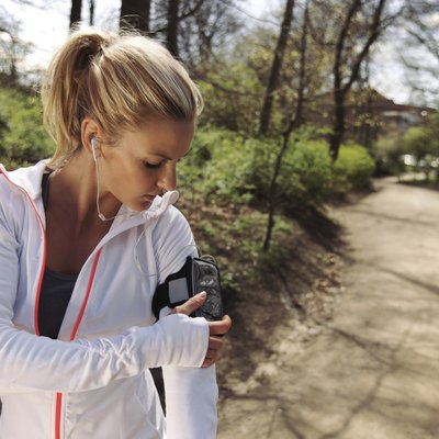 Female runner monitor her progress on smartphone