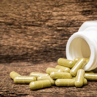 Herb capsule spilling out of bottle