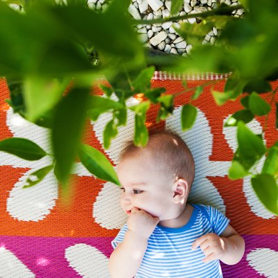Baby Boy is Lying Down in the Backyard