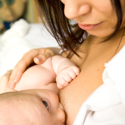 Young woman breastfeeding a baby