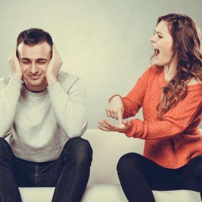 couple having argument - conflict, bad relationships. Angry fury woman screaming man closing his ears.